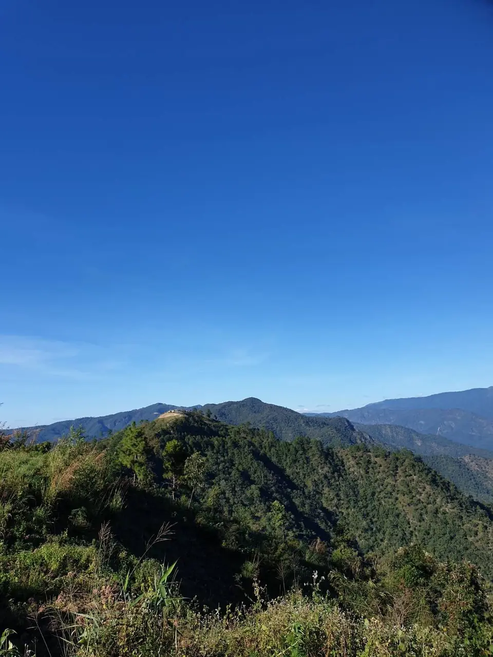 Forested hills around Chiang Dao under a clear blue sky